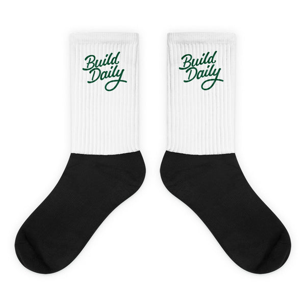 White and black socks with green build daily signature logo