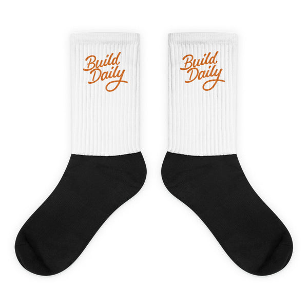 White and black socks with orange build daily signature logo