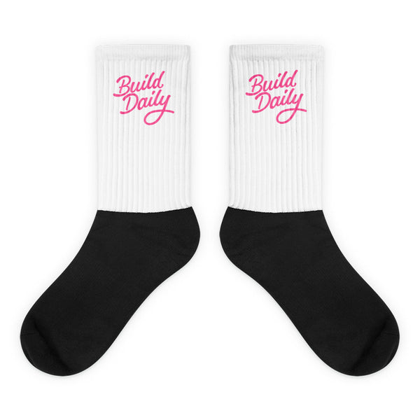 White and black socks with pink build daily signature logo