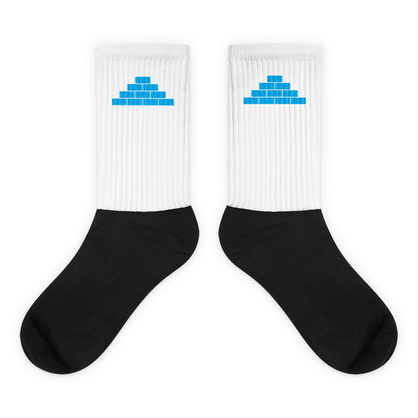 White and black socks with light blue build daily brick by brick logo