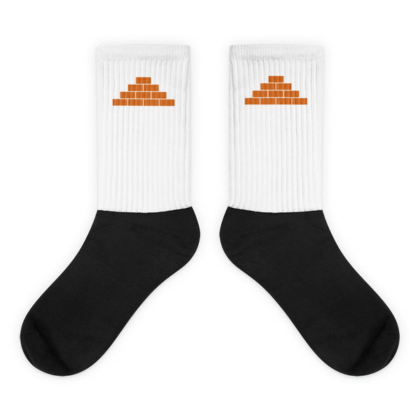 White and black socks with orange build daily brick by brick logo