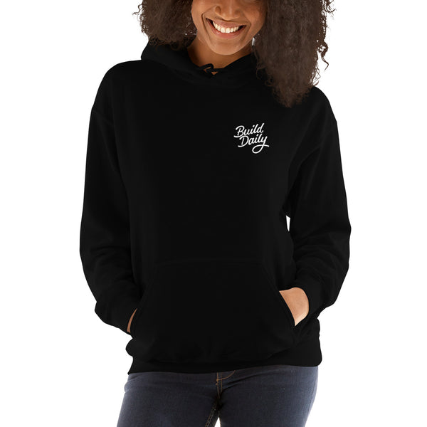 Woman wearing black hooded sweatshirt with white build daily signature logo