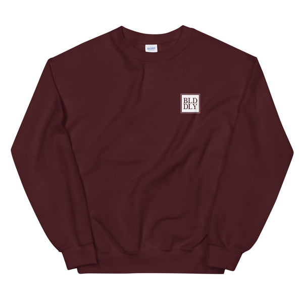Maroon crewneck sweatshirt with white build daily monogram logo