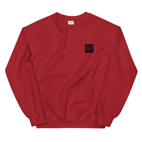 Red crewneck sweatshirt with black build daily monogram logo