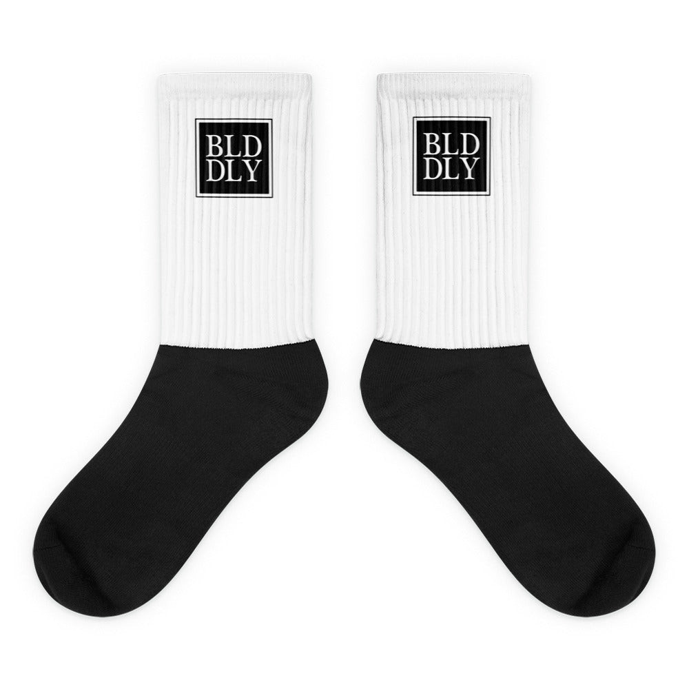 White and black socks with black build daily monogram logo